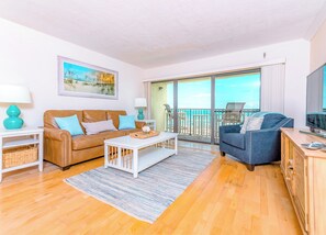 Spacious living room with cozy seating and a private balcony view