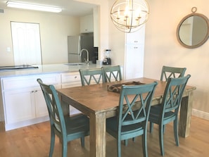Charming dining area with rustic-style seating and a modern kitchen backdrop