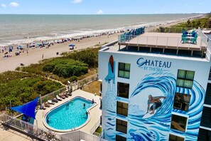 Breathtaking aerial view of the pool and beach at Chateau by the Sea
