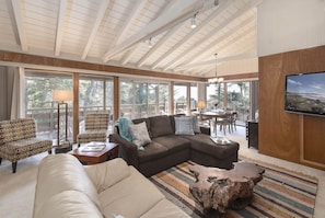 Living Room has a Distant Ocean View Through Treetops