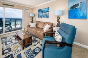 Very inviting Pelican Isle 410! - The living room features a queen-sized sleeper sofa, allowing the condo to sleep six.