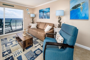 Very inviting Pelican Isle 410! - The living room features a queen-sized sleeper sofa, allowing the condo to sleep six.