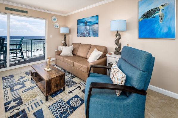 Very inviting Pelican Isle 410! - The living room features flat screen TV and a queen-sized sleeper sofa, allowing the condo to sleep six.