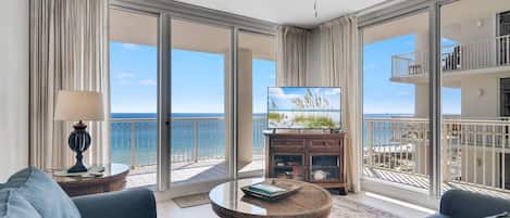 Living room with sleeper sofa, flat screen TV, and beautiful Gulf-front views.
