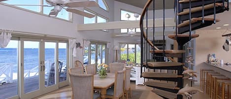 Dining area with vaulted ceilings and ocean views.