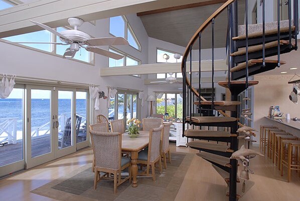 Dining area with vaulted ceilings and ocean views.