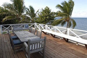 Al fresco dining on the villa's beachfront deck.	