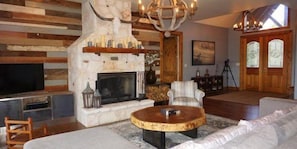 Grand stone wood burning fireplace in the living area