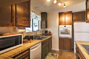 Prepare delicious home-cooked meals in the fully equipped kitchen.