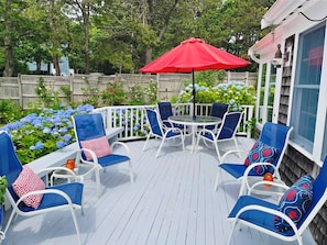 Outdoor deck with plenty of seating, table, umbrella and charcoal grill - 58 Longs Lane Chatham Cape Cod New England Vacation Rentals