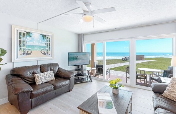 A cozy and stylish living room with a breathtaking view of the ocean, perfect for relaxation.