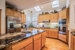Fully-stocked gourmet kitchen-granite counters, stainless appliances