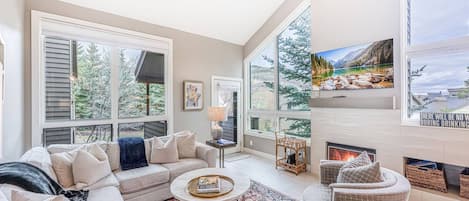 The living room is the heart of this perfect mountain retreat! Snuggle up on the comfortable sofa or get cozy by the gas fireplace. It's the blend of