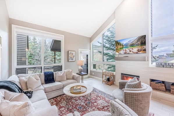 The living room is the heart of this perfect mountain retreat! Snuggle up on the comfortable sofa or get cozy by the gas fireplace. It's the blend of
