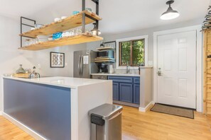 Kitchen, located off front entry, features a coffee bar with drip coffee maker and Keurig, blender, mixer and crock pot