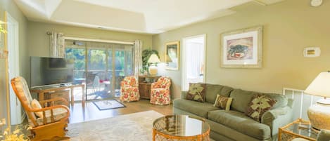 Relax & unwind in this comfortable living room with screened-in porch overlooking the inlet!