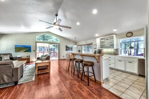 Bright, clean open kitchen, seating for 3 at the counter.