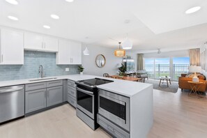 Sleek and modern kitchen with an open-concept layout, seamlessly flowing into the living area.