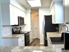 Kitchen - Features stainless steel appliances with lots of cabinet & counter space