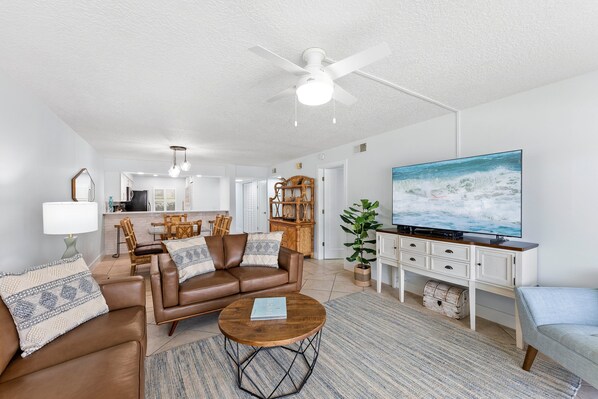 Living room with oversized sofa and large flat screen TV