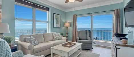 Views of the Gulf from all angles of this tastefully decorated living area with a sofa sleeper and wall mounted TV.