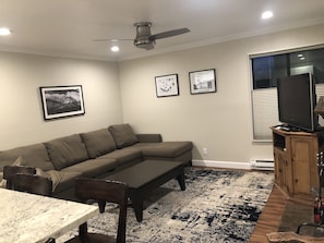Living room with TV, sofa sleeper, and fireplace