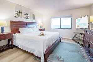 Serene master bedroom offers plush bedding soft hues and a relaxing retreat with Smart TV.