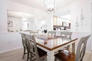 Bright dining area is perfect for shared meals with elegant coastal charm.