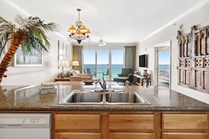 Fully equipped kitchen with view of living room.