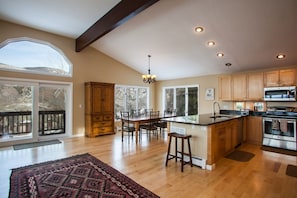 Views of kitchen, dining table that seats 6 and access to large wrap around deck with gas grill and mountain views.
