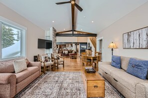 Toward kitchen under vaulted ceiling from fireplace in sitting room
