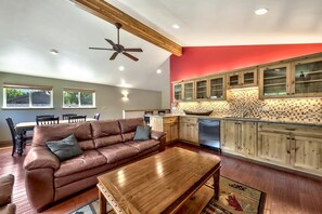 Upstairs family room with comfortable furnishings and a wet bar