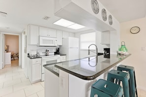 Well equipped kitchen with 3 bar stools