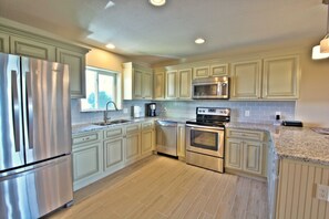 Kitchen is well appointed with granite countertops and stainless applainces