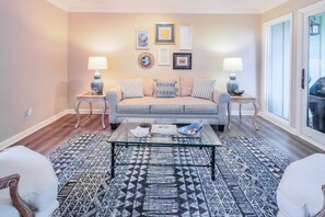 The living room connects to both the entryway & front door as well as the back patio.