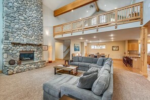 Flow seamlessly between the living room, loft, dining area, and kitchen in this spacious great room