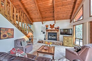 The family room offers a sumptuous leather couch and a wood-burning fireplace.