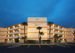 Beautiful resort exterior with palm trees and a welcoming atmosphere.