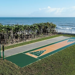 Enjoy a friendly game of shuffleboard just steps from the beach.
