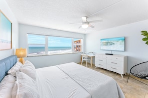 Serene master bedroom with a king-sized bed, contemporary decor, and ample natural light.