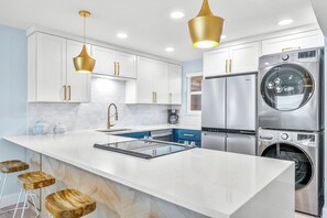 This sleek, modern kitchen with high-end appliances perfect for cooking up memories.