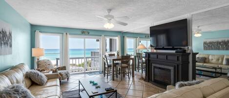 Living room area with deck access and gulf views.