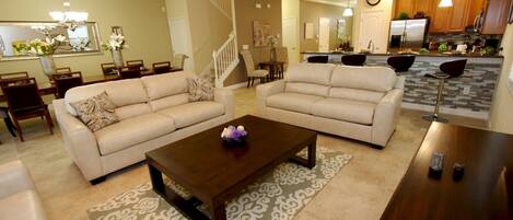 Living space welcomes you with three comfortable couches and large television