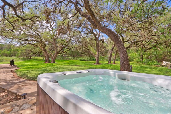 Private hot tub with views of the back yard