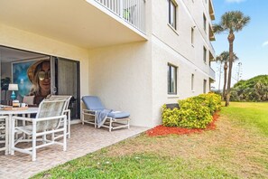 Private ground-floor patio perfect for lounging, reading, or sipping coffee in the coastal breeze.