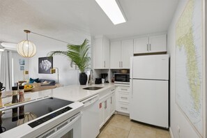Cook, sip, and savor in this bright kitchen! Fully stocked for easy meals, with open flow to the cozy living space.