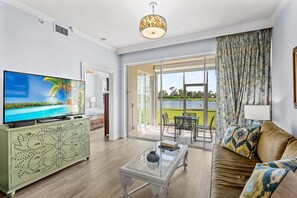 Living Room with Brand New Furniture and Flat Screen HDTV; Entrance to Lanai Area with Golf and Lake Views; Totally Redecorated! Couch is a Pullout!