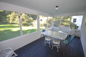 Screened-in porch facing spacious backyard