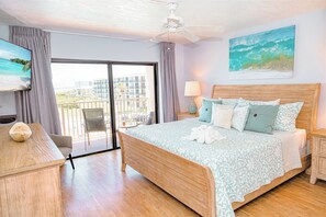 Master bedroom with a king-size bed and direct ocean views, perfect for relaxation.