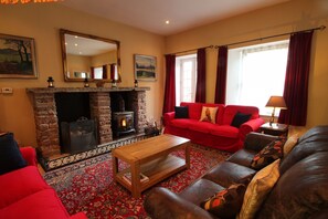 Spacious yet cosy sitting room with woodburning stove.